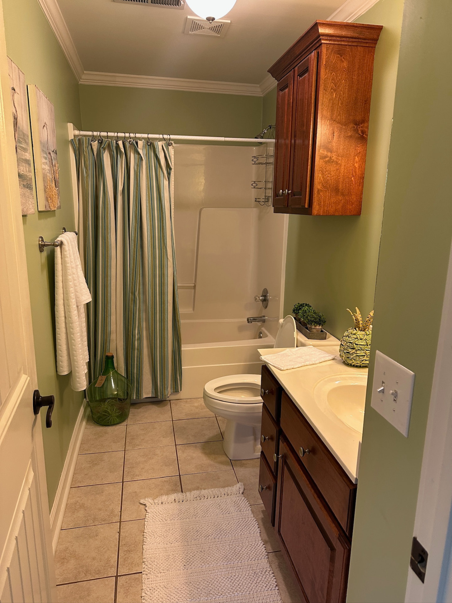 Full bathroom with tub, shower and wood cabinetry
