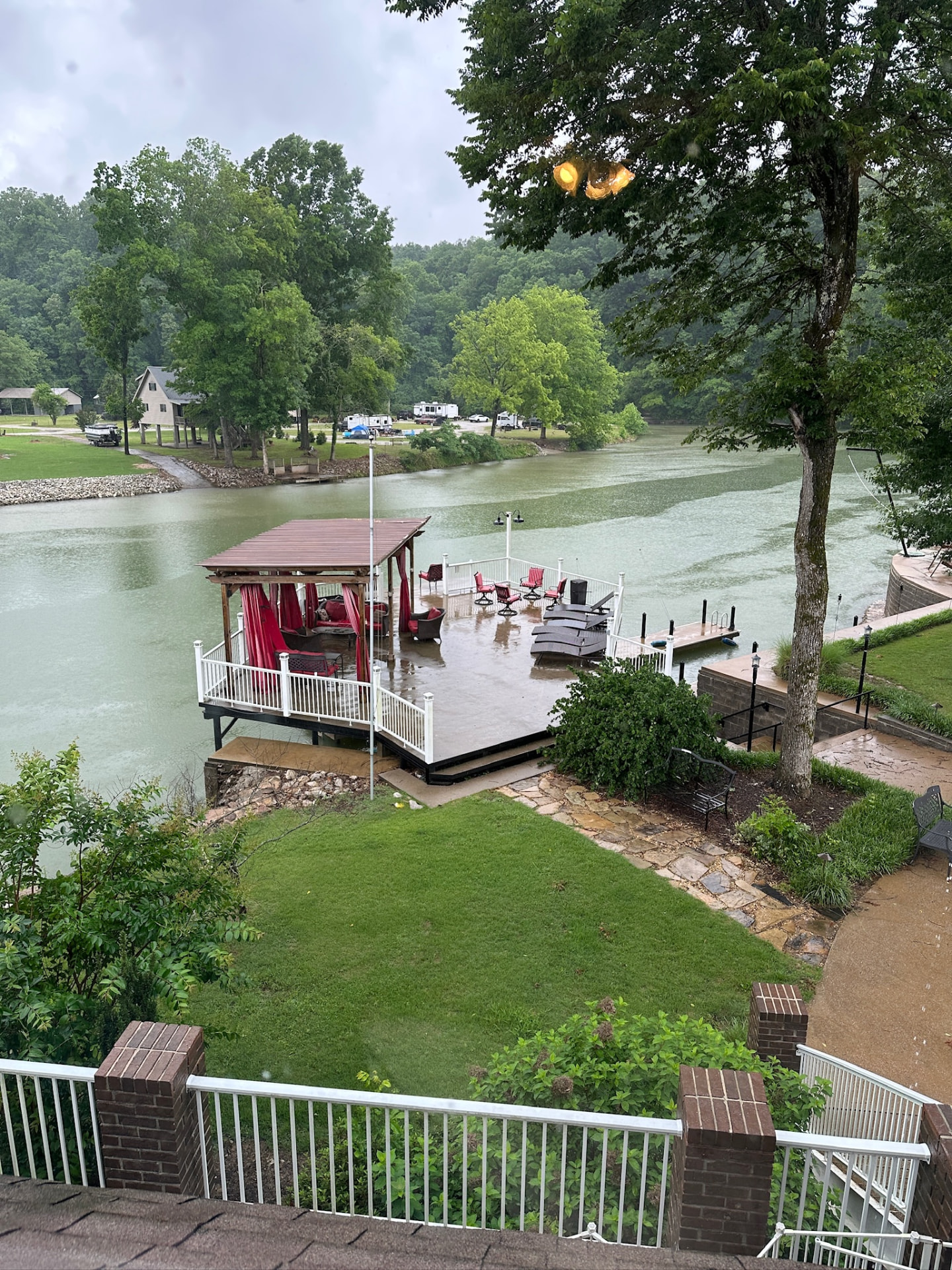 Aerial view of the covered dock pavilion, red curtains and open water