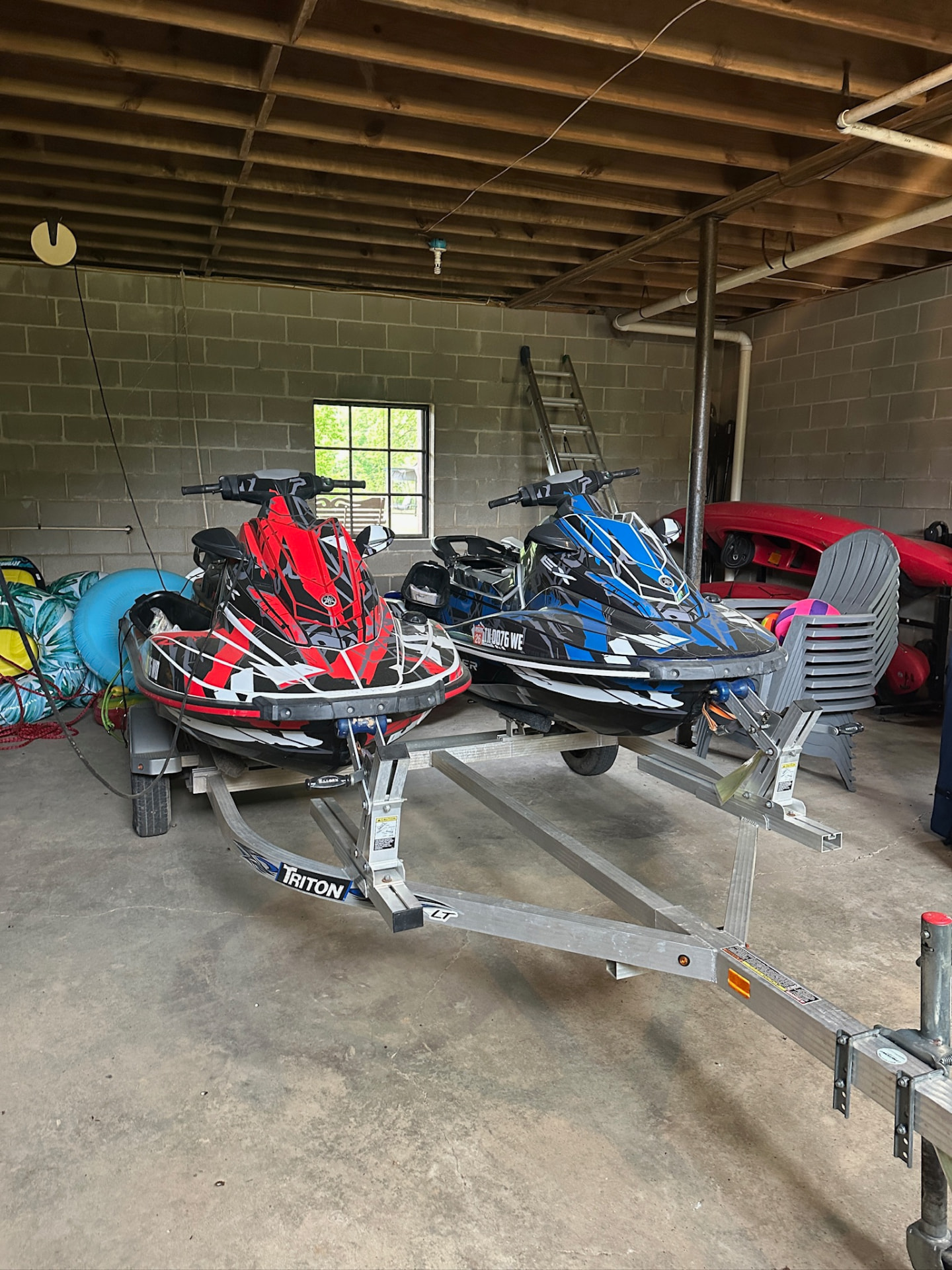 Jet skis, tubes and lake chairs stored in the boathouse