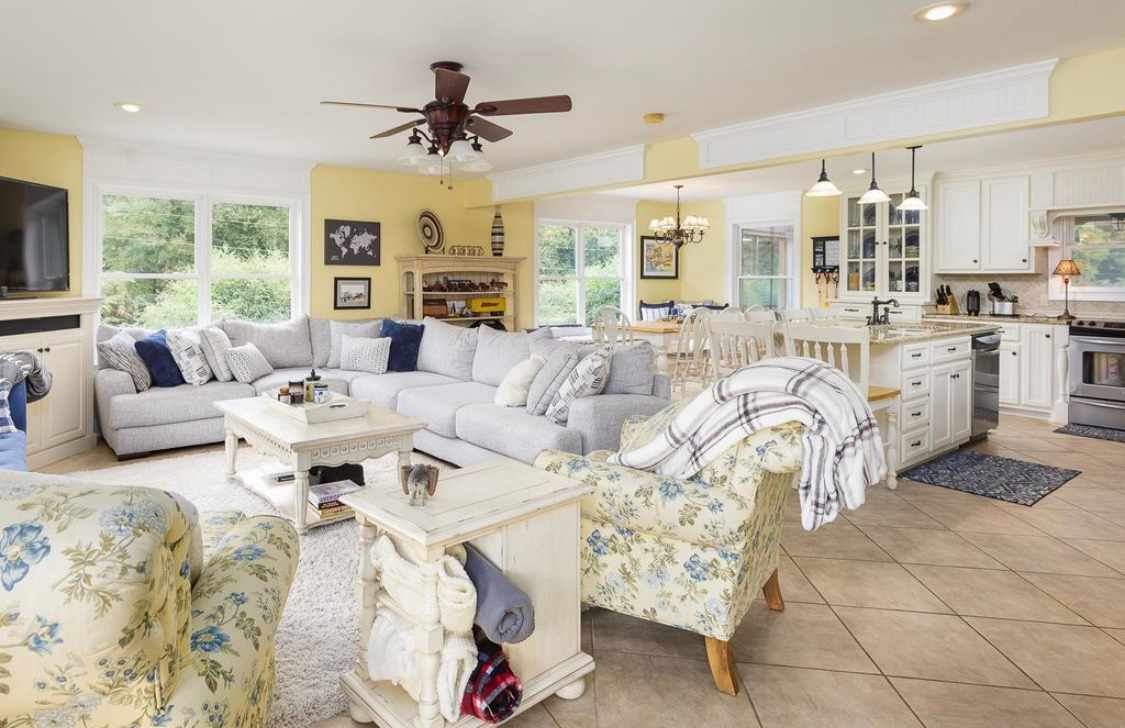 Open living room, dining area and kitchen with lake views