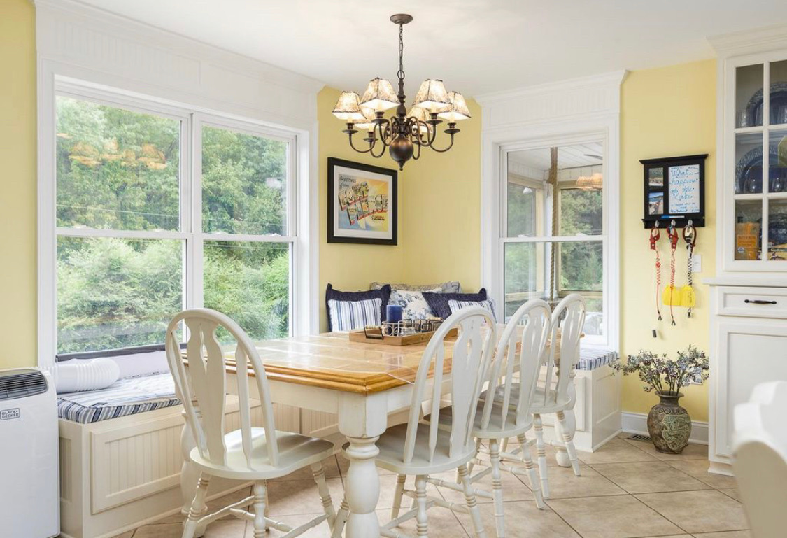 Sunny dining nook with built-in bench seating and garden views