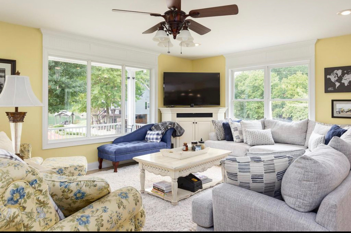 Bright living room with lake-view windows and comfortable seating