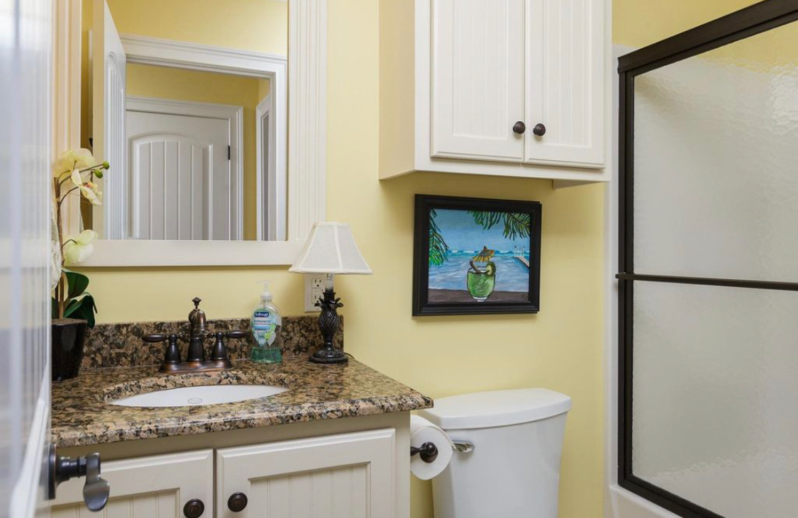 Full bathroom with granite vanity and shower