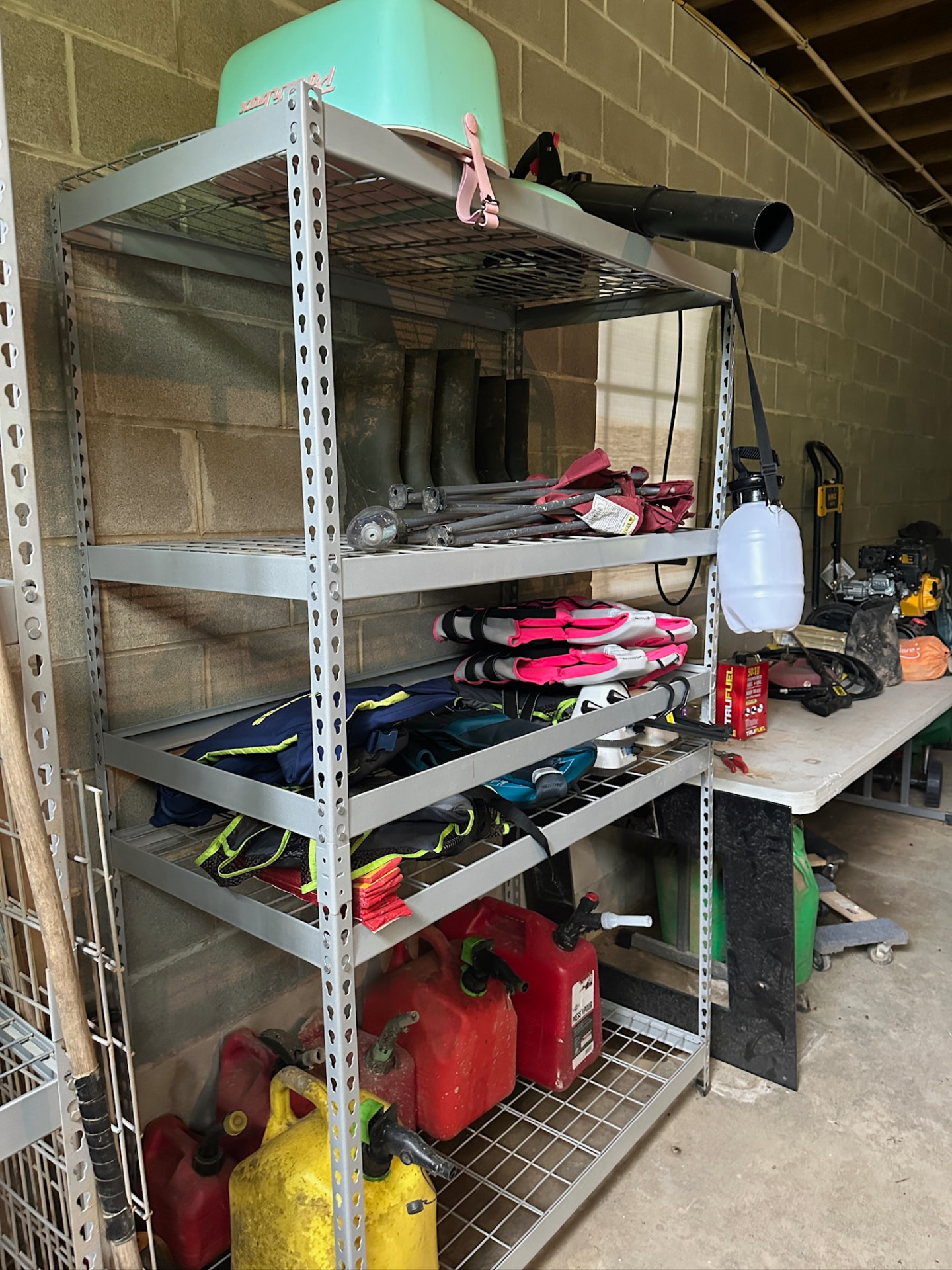 Life jackets, fuel cans and lake gear organized on shelves