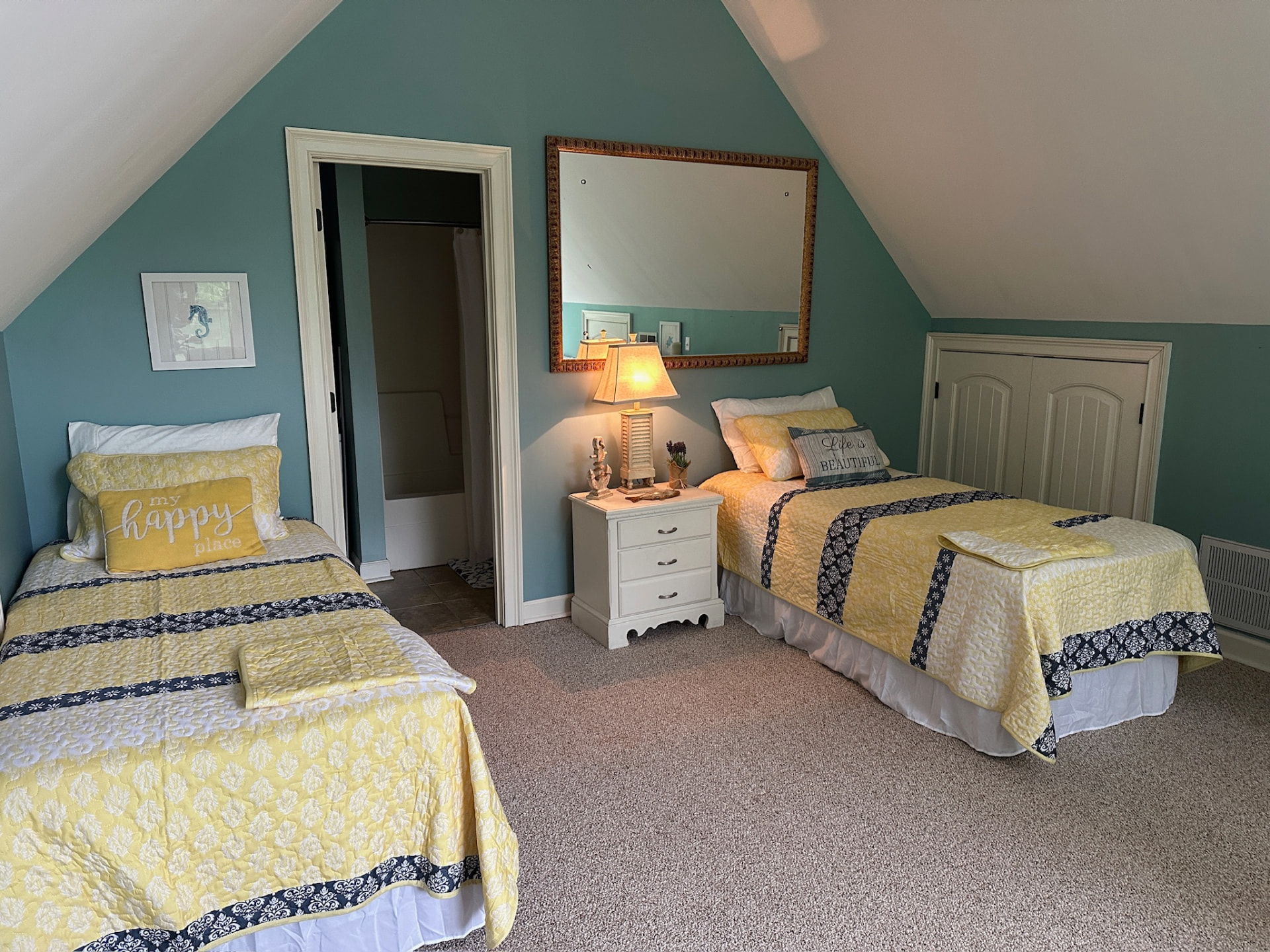 Bedroom with two beds and en-suite bath access