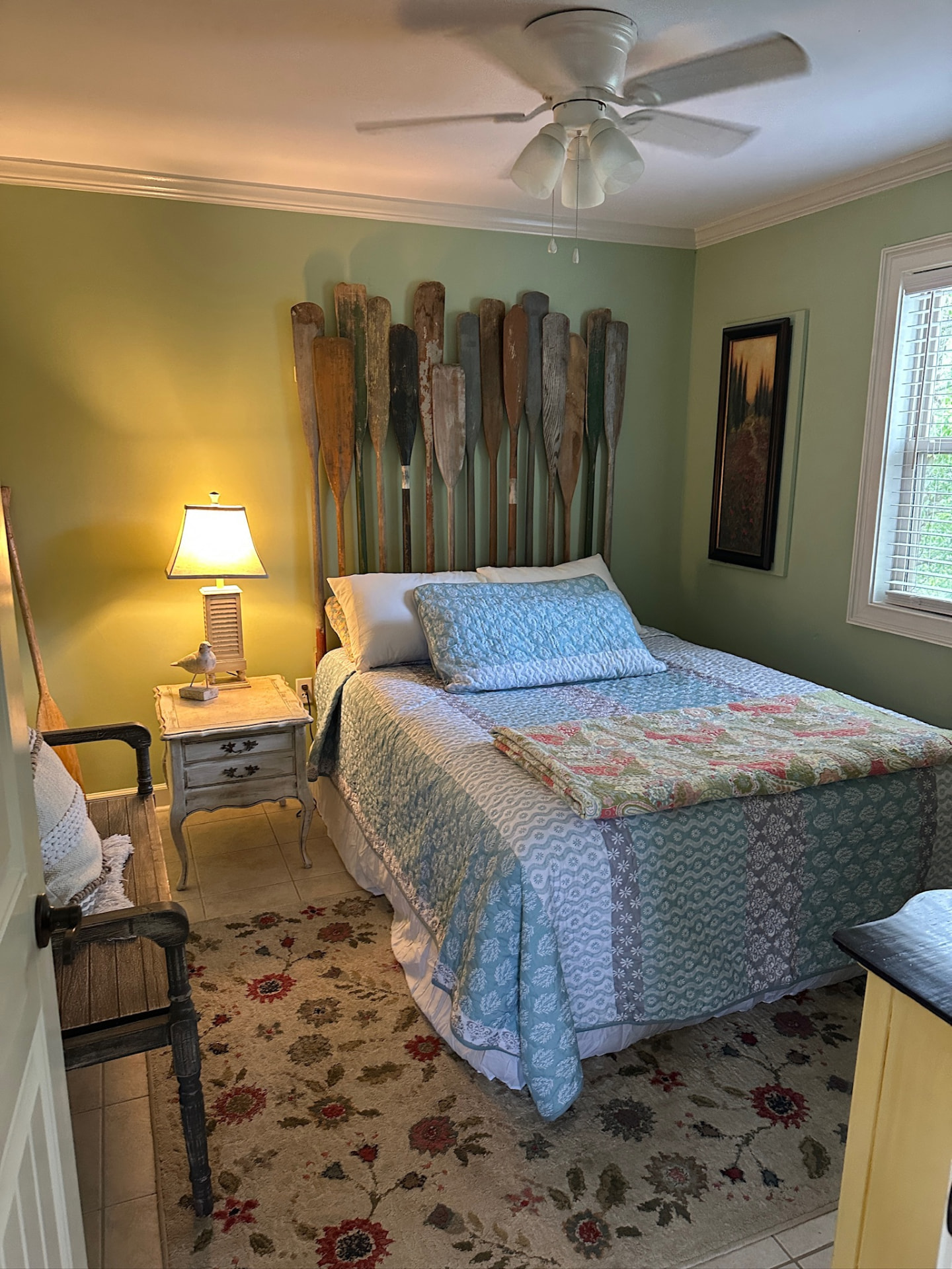 Bedroom with decorative oar headboard and cozy furnishings